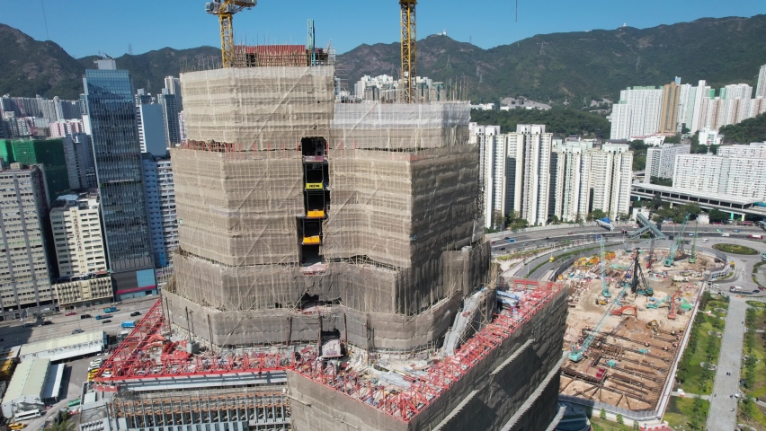 Sport theme commercial residential facility construction site in Kai Tak Hong Kong city, Kwun Tong and Kowloon Bay near Victoria harbor, Aerial drone | Shutterstock HD Video #1092850301