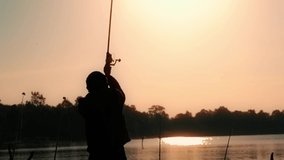 Slow motion video of a man swinging a fishing rod in the morning sun.