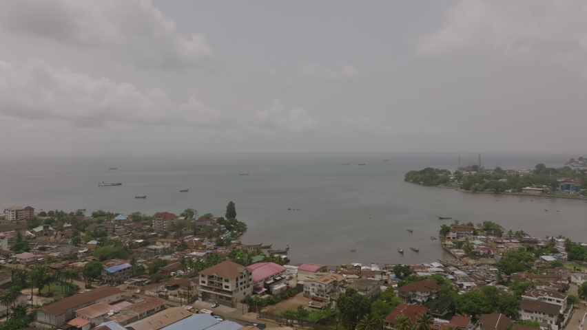Aerial flyover of a bay that is off of downtown Freetown, Sierra Leone.