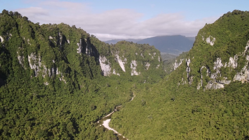 Spectacular view of Fox River in canyon surrounded by massive limestone cliffs and native New Zealand rainforest. Birds eye view