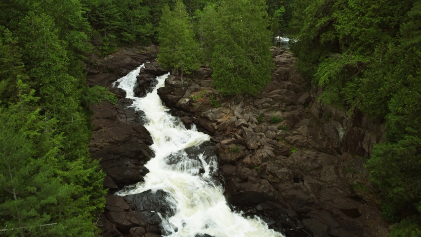 aerial drone of Oxtongue Falls at Algonquin Park, Ontario, Canada. Ragged Falls Provincial Park. water of waterfall roaring and pouring down cliff in Algonquin Highland.