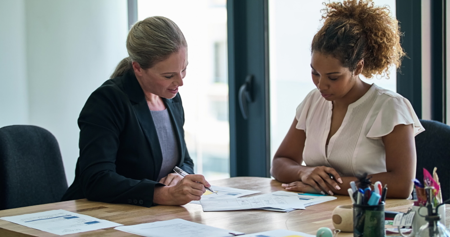 Finance lawyer discussing signing legal paperwork in a meeting at her law firm office. Confident, professional and serious attorney giving advice on the financial banking contract agreement to Royalty-Free Stock Footage #1092856115