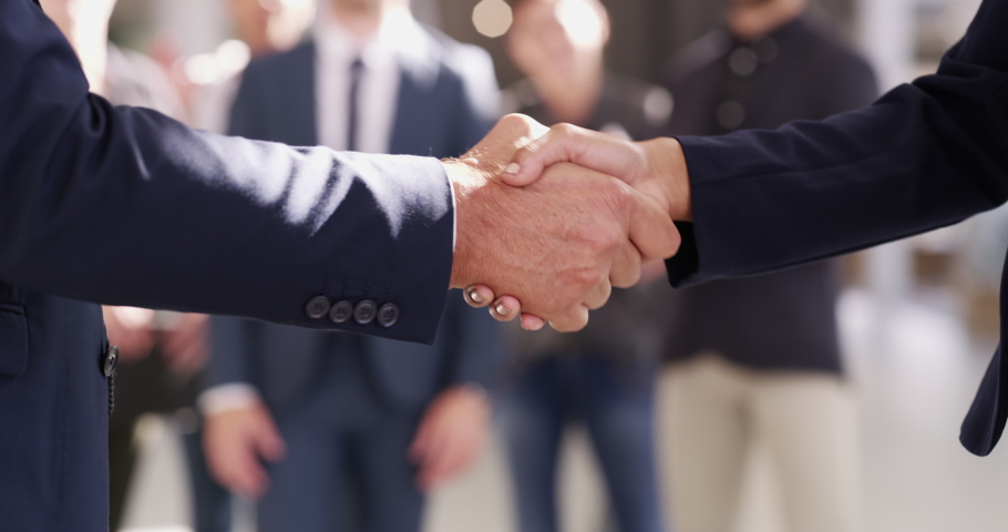 Handshake, agreement and partnership between business people meeting and greeting. Closeup of corporate or political leaders handshaking after a successful deal outside with applause from an