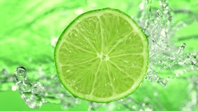 Super Slow Motion Shot of Rotating Fresh Lime Slice and Splashing Water at 1000fps. - Powered by Shutterstock - Get 15% off with code: PIKWIZARD15