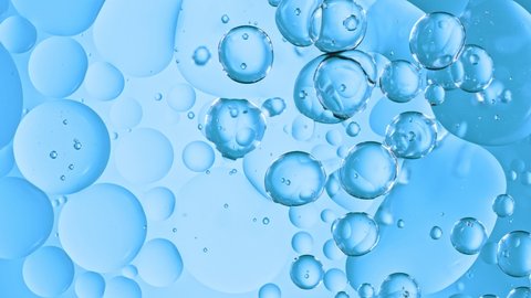 Super Slow Motion Shot of Moving Oil Bubbles on Blue Background at 1000fps. - Βίντεο στοκ
