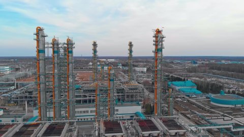 Aerial view of the pipeline and distillation columns at a large fuel processing plant. A crude oil and gas refinery in Russia or Canada is operating at full capacity during a fuel crisis.