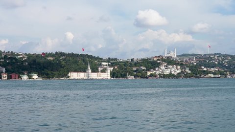Real time panorama clip of Bosphorus with Kuleli Military High School, Camlica Mosque and Camlica Radio TV tower on the hill on a sunny and cloudy summer day. Taken from Arnavutkoy, Istanbul, Turkiye