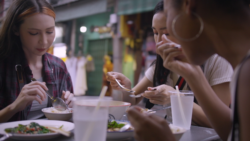 A group of multi-ethnic female friends enjoying street food on Yaowarat Road or Chinatown in Bangkok, Thailand. Royalty-Free Stock Footage #1092860781