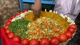 Extremely close up shot of a vendor selling the famous Ghugni chat or chickpea curry on a Kolkata street. India. no face video