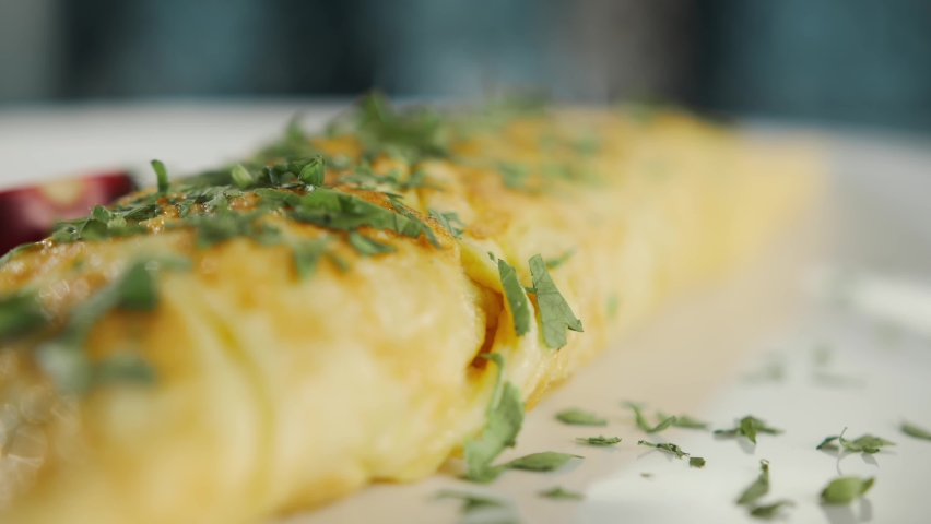 Close-up: French omelette with herbs in professional kitchen