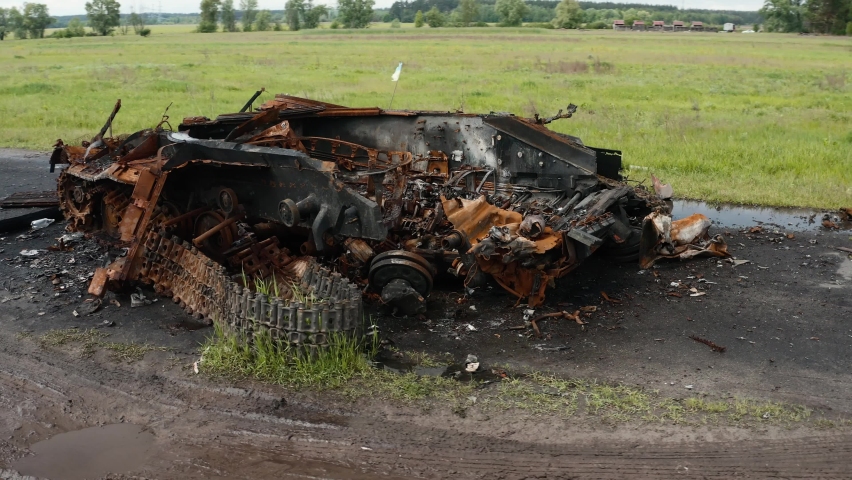 A destroyed tank, detonation of ammunition, a drone flies around a destroyed tank with a detached tower.