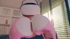Asian sportswoman using innovative technology VR glasses for exercise. Attractive beautiful girl wearing virtual reality headset and holding gaming controller while doing boxing fight workout at home.