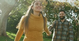 Video of happy caucasian warmly dressed spending couple in the garden. Domestic lifestyle and leisure time in the garden.