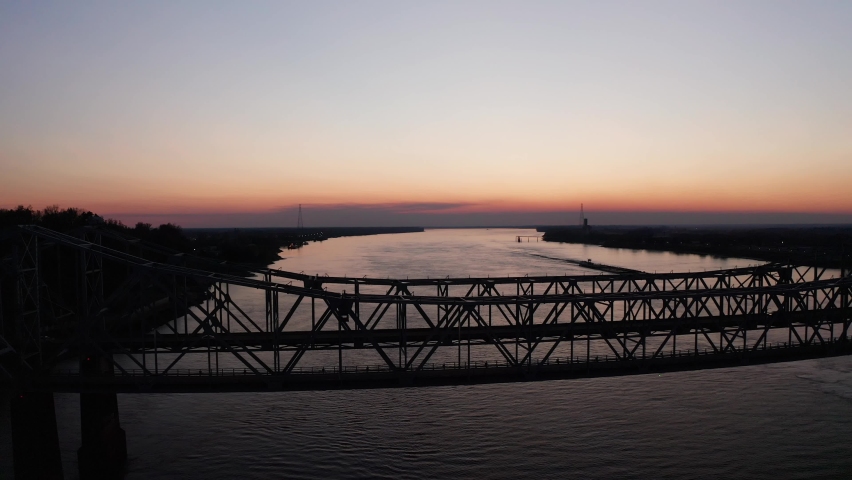 Wide panning aerial shot of the Bridge on the Mississippi River at sunset. 4K