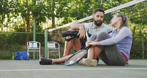 Video of happy caucasian couple on having break the court. Healthy active lifestyle and fitness at home.