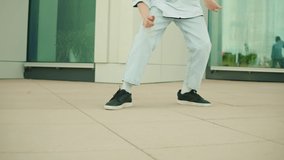 Young man breakdancer dancing hip hop. Modern dance choreography. Male professional dancer showing dance movings outdoor. Musical video.