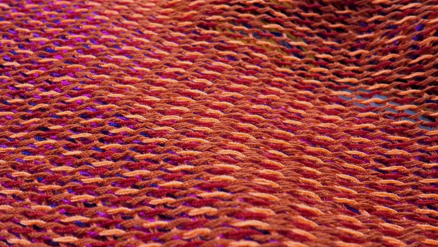Knitted fabric cloth suface. Fiber material for handcraft knitting. Thread in form of net or web. Copy space for text. Textile abstract background. Detailed texture of shiny cloth Royalty-Free Stock Footage #1092889039