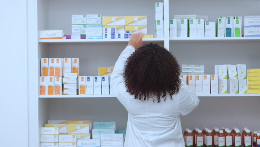 Pharmacist, medical and healthcare professional in pharmacy showing, choosing and helping with medicine product. Portrait of smiling, happy and friendly woman selling drugstore medication and cream