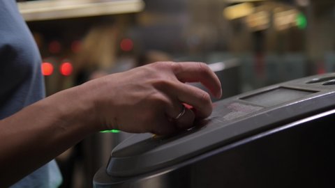 Subway turnstile. A person passes through the turnstile using an electronic touch card. Entrance fee