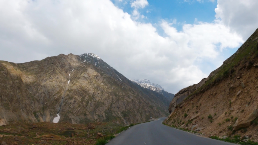 4K POV hyperlapse of car passing through road covered by high Himalayan mountains in Lahaul and spiti district at Himachal Pradesh, India. Mountain road with valley view and clouds in sky  | Shutterstock HD Video #1092915173