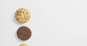Video of biscuits with chocolate over white background. cookies,bake, food, candy, snacks and sweets concept.