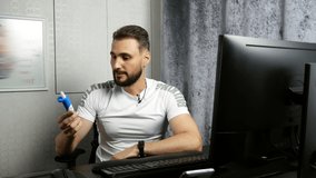 young bearded business coach giving online lesson about vision correction drops while working at computer