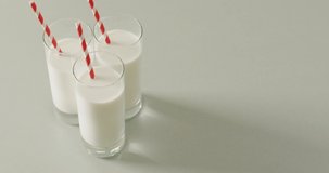 Video of three glasses of milk on white background. dairy products and healthy organic nutrition.