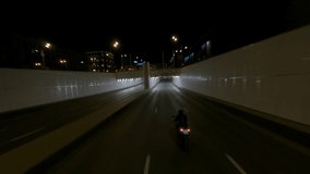 Fast BMW motorcycle rides through city tunnel in the night, fpv drone shot - Powered by Shutterstock - Get 15% off with code: PIKWIZARD15