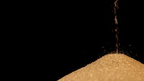 Hourglass. Sands move through hour glass. Sandglass close-up on a black background. Slow motion video. A pile of Golden sand at the bottom of the hourglass, small grains of sand fall from above. - Powered by Shutterstock - Get 15% off with code: PIKWIZARD15