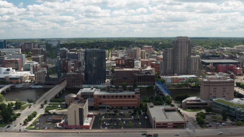Grand Rapids, Michigan skyline with freeway drone video wide shot moving down.