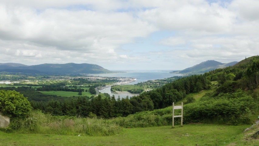 Aerial flight of the flagstaff viewpoint area, countryside, Newry, with Warrenpoint town in the distance during the summer. Hiking and Tourism concept