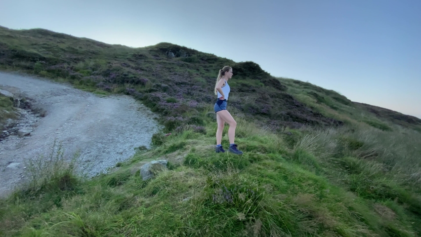 Young woman stands before Ireland