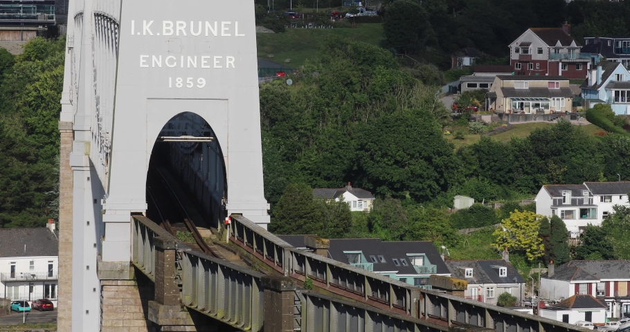 The Royal Albert Bridge Over the River Tamar built by Isambard Kingdom Brunel with a Cross Country Train Crossing Over the Bridge on a Summer's Day in England. Royalty-Free Stock Footage #1092932797