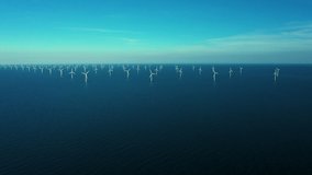 Aerial drone shot of oceanic wind turbines at the Rødsand wind farm in Denmark. Green energy is a promising alternative to fossil fuels and the need for a transition is urgent.  - Powered by Shutterstock - Get 15% off with code: PIKWIZARD15