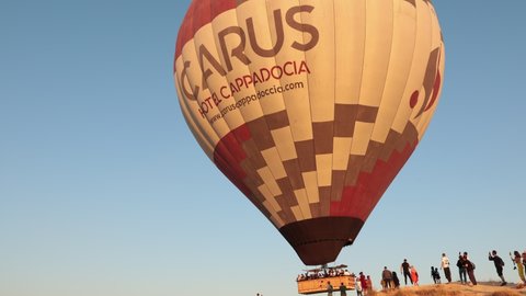 Goreme, Turkey - July 7, 2021: group of tourists lifted into the sky in a h...