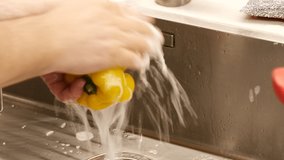 Washing vegetables with soap at the kitchen sink