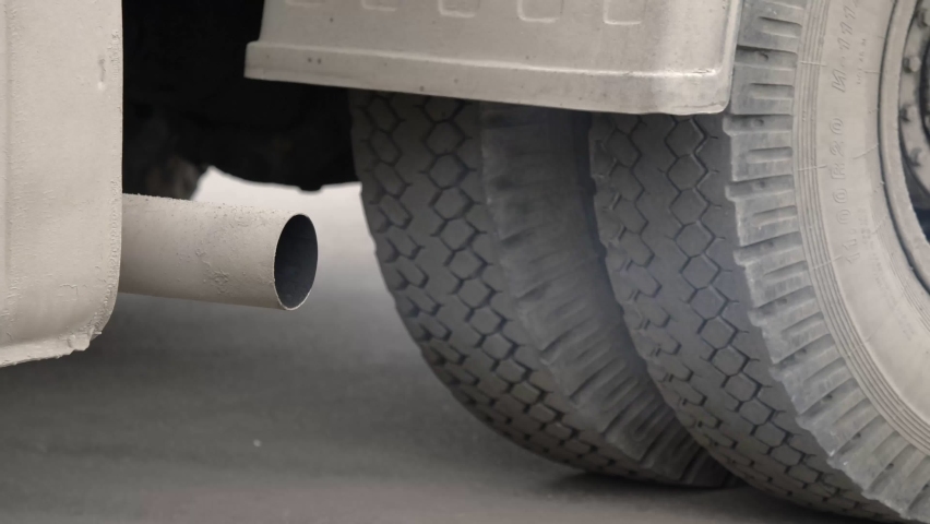 large vehicle with the engine running that discharges combustion products from the exhaust pipe