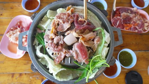 Grilled meat on pan for party of people, grill pork food on hot pot and soup for meeting, dilicious menu for people and family party, rosated meat for cooking to eat, fresh raw food spicy tasty menu  