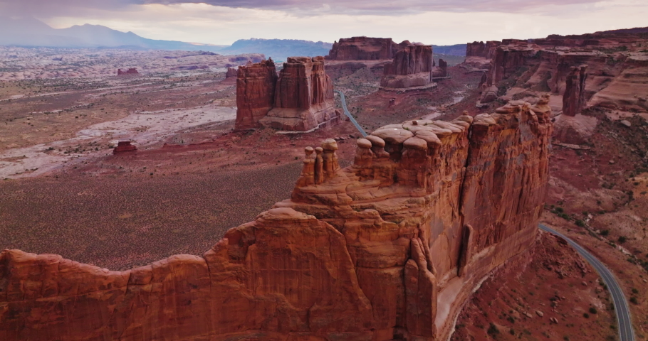 Weird rock formation of Bryce canyon in Utah, USA. Drone footage over the stunning rocks and highway crossing the dessert.