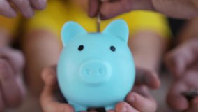 Close-up of hand throwing coins into piggy bank. Financial and business safety. Coins in piggy bank symbol of bank safety. Financial savings are kept in bank. Business and financial safety concept - Powered by Shutterstock - Get 15% off with code: PIKWIZARD15