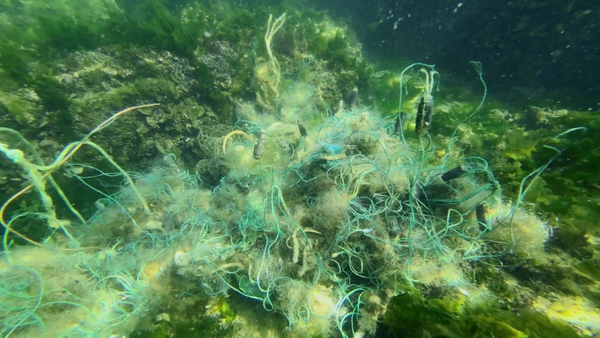 Lost fishing gear lies underwater on the seabed. Problem of ghost gear - any fishing gear that has been abandoned, lost or otherwise discarded. It is the most harmful form of marine debris Royalty-Free Stock Footage #1092957219