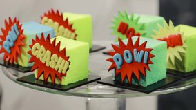 Crash! Pow! Decorated cakes with popular phrases from comics book on them. Cartoon comics style decorated desserts on some superheroes cosplay party. Close up - Powered by Shutterstock - Get 15% off with code: PIKWIZARD15