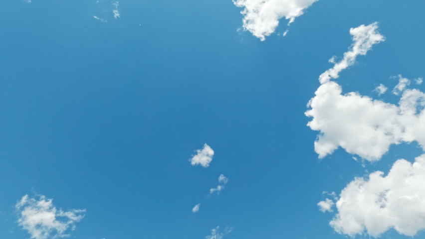 Clear sky. Dreamful day. Tranquil mind. Clean blue heaven with light white single clouds creating in high flying away. Royalty-Free Stock Footage #1092958417