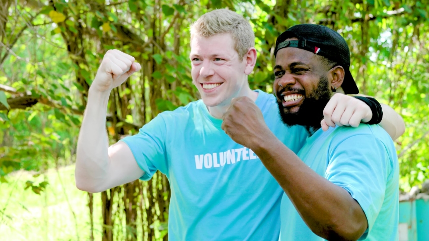 Young man interracial people wearing volunteer t shirt at excited for success with arms raised celebrating victory smiling. winner concept, environmental protection and ecology, reduce global warming Royalty-Free Stock Footage #1092958607