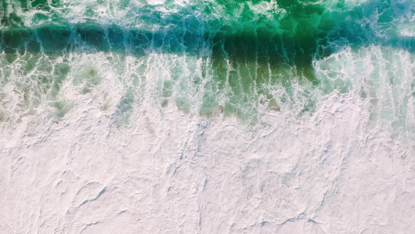 Beautiful texture of big power green ocean waves with white wash. Aerial top view footage of fabulous sea tide on stormy day. Drone shot breaking surf with foam in Pacific ocean. Big swell in Cali | Shutterstock HD Video #1092963433