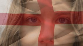 Animation of flag of england over caucasian woman at beach. National flags, patriotism and holiday concept digitally generated video.