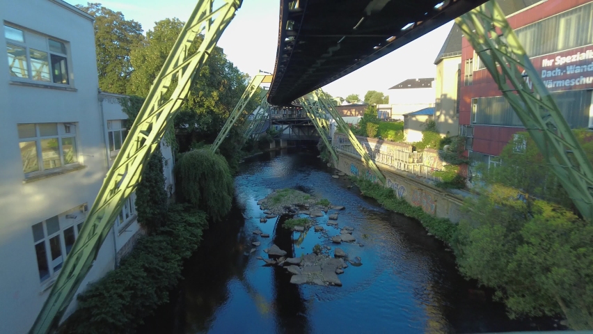 Riding along with the upside down train in wuppertal, Germany on a sunny day.