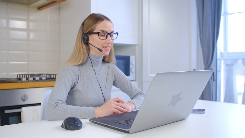 Call center operator in headset. Online support specialist speaking with client. Help desk manager talks to customer on video call | Shutterstock HD Video #1092977093
