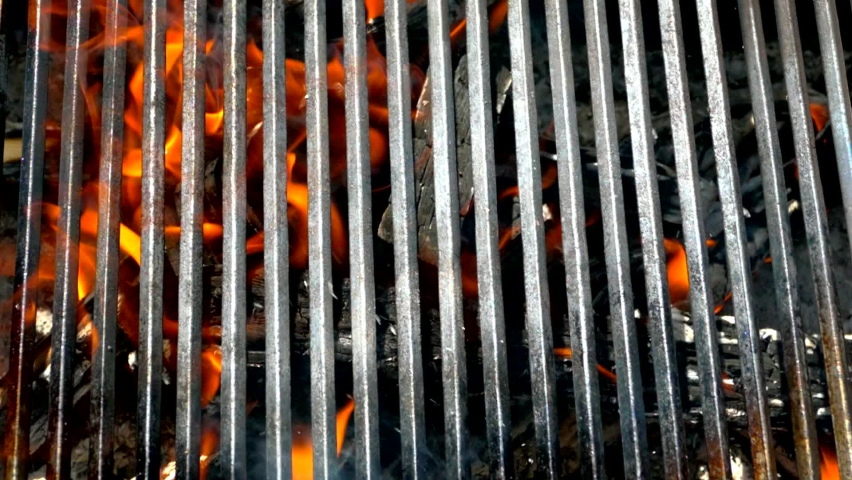 Grill grill on the background of heat and fire. Royalty-Free Stock Footage #1092977261