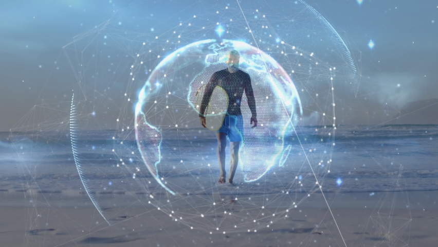 Animation of illuminated globe with rays against african surfer walking at beach. Digital composite, multiple exposure, digital interface, technology, global science, wellbeing, sports, leisure